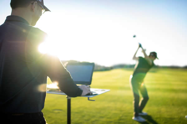 Fitter watching golfer hit shots