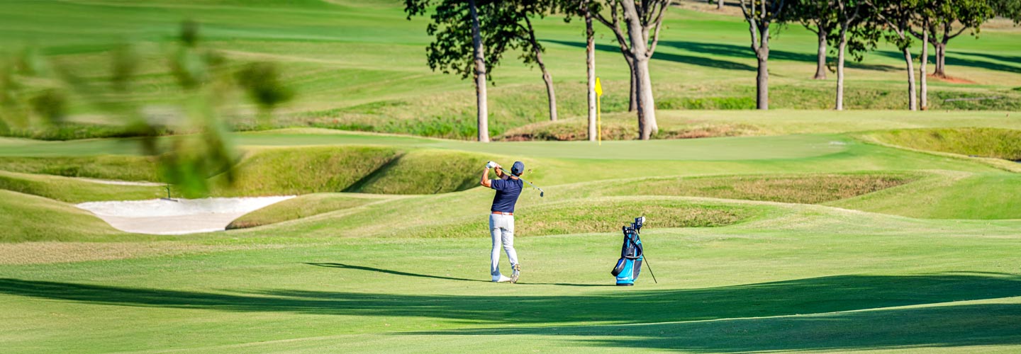 Lifestyle image of a male golfer golfing on a golf course