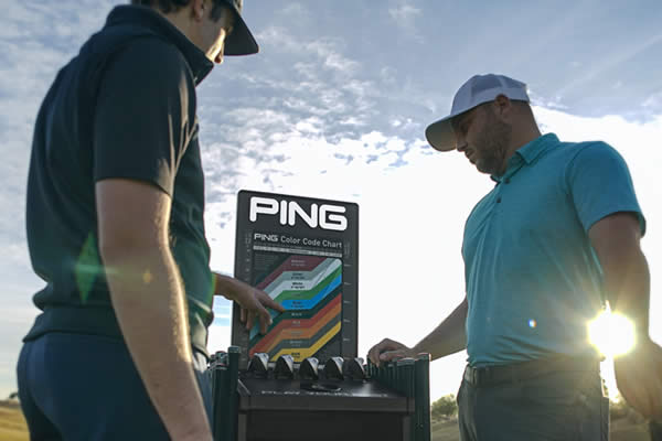 Fitter and golfer reviewing PING Color Code Chart
