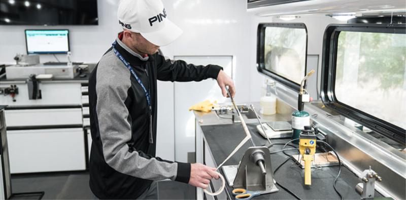 Technician regripping a club inside the Tour Truck